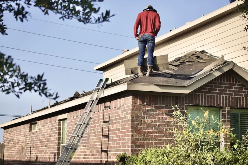 Professional roofer working on a residential roof in Kalamazoo